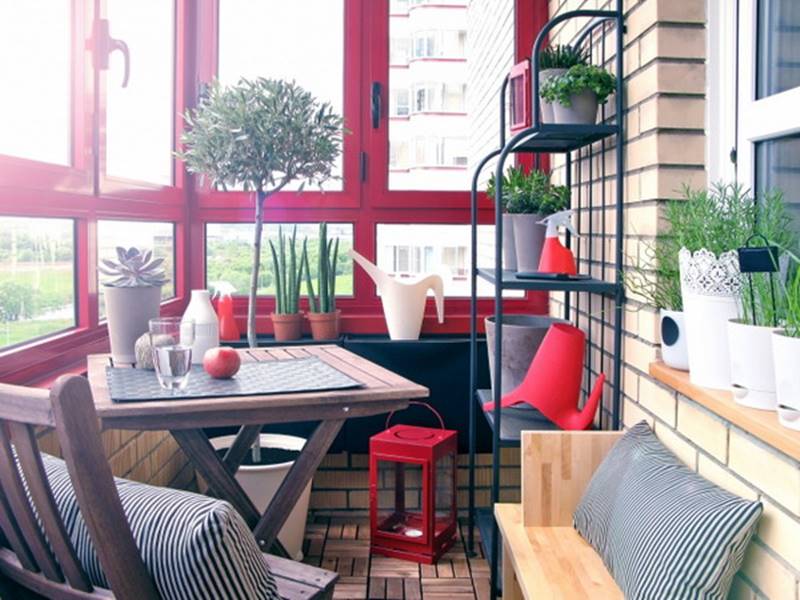 Closed tiny balcony with a red window frame