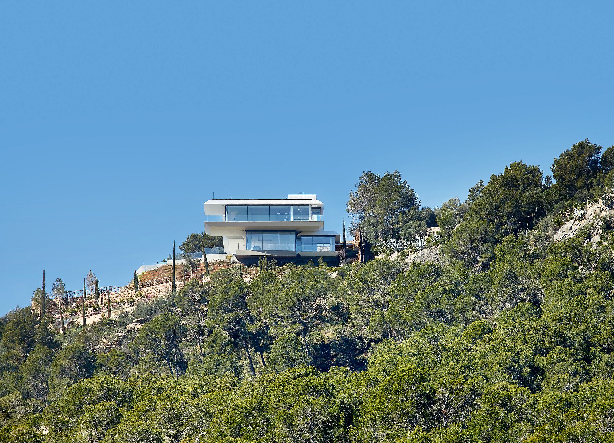 Contemporary home seems to float above the rocky landscape effortlessly