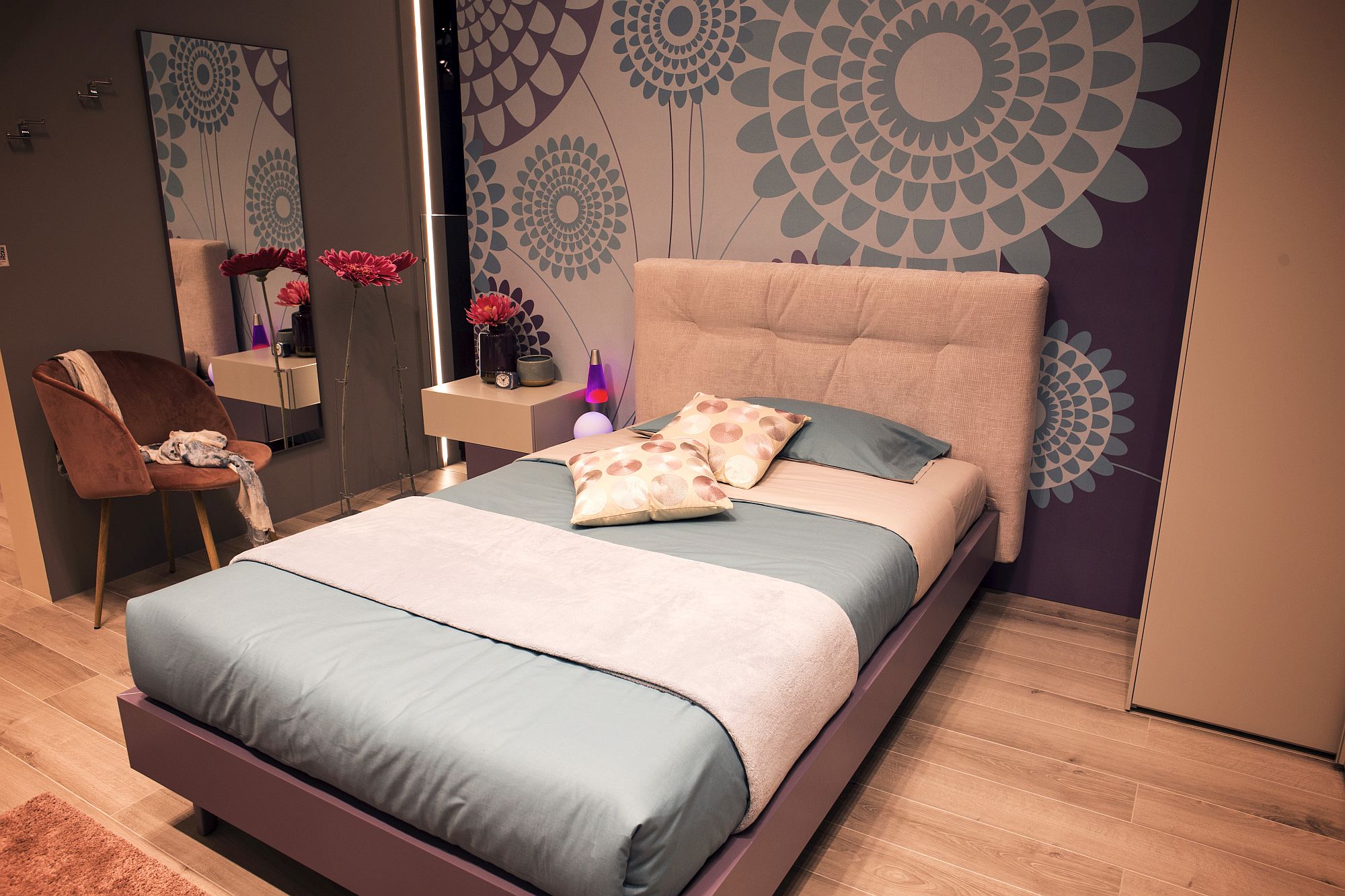 Flowers and the pattern of the backdrop add feminine charm to the girls' bedroom