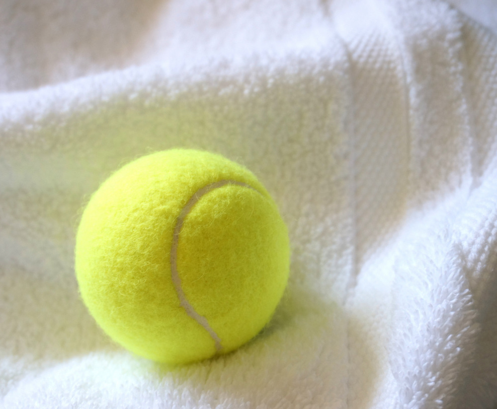 Fluff towels with a tennis ball