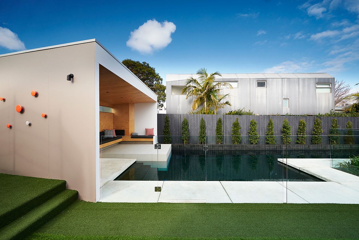 Glass walls separate the outdoor area from the pool space