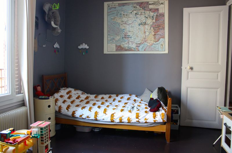 Gray kids room with a wooden vintage bed