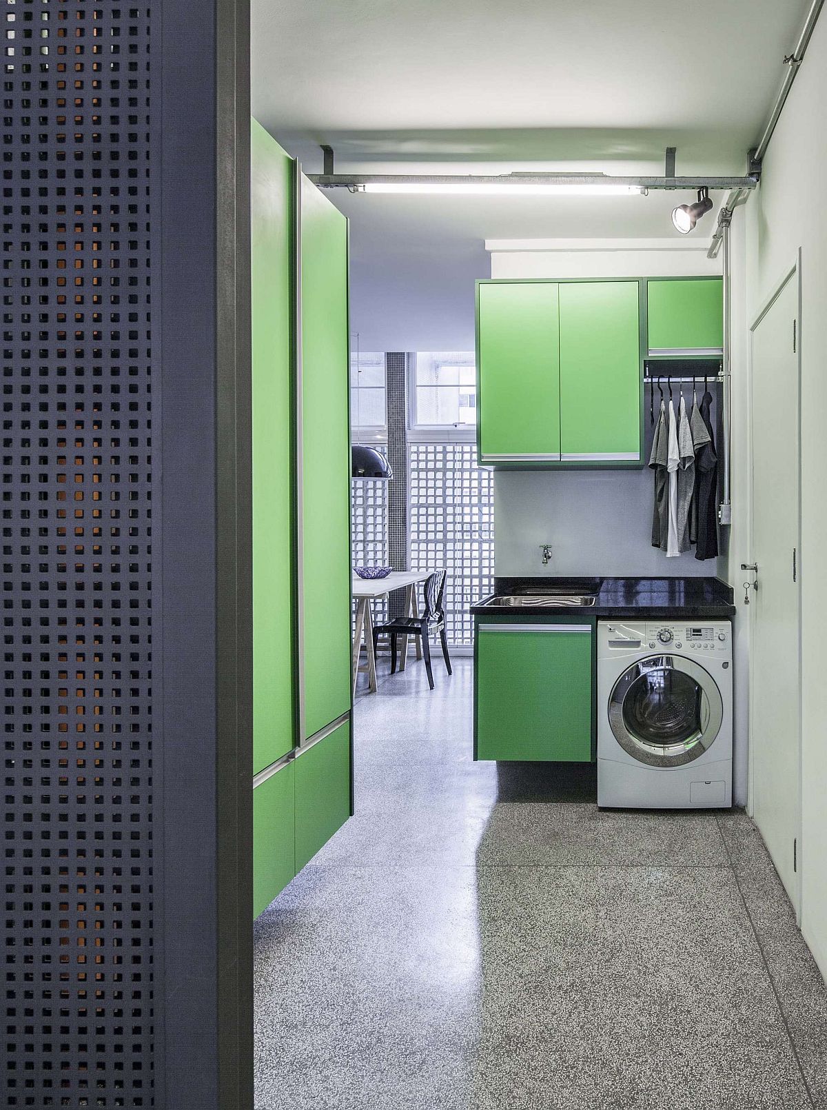 Laudry area and kitchen with colorful cabinets in parakeet green