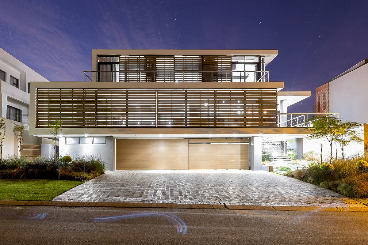 Lighting adds to the unique timber screen clad facade of the home