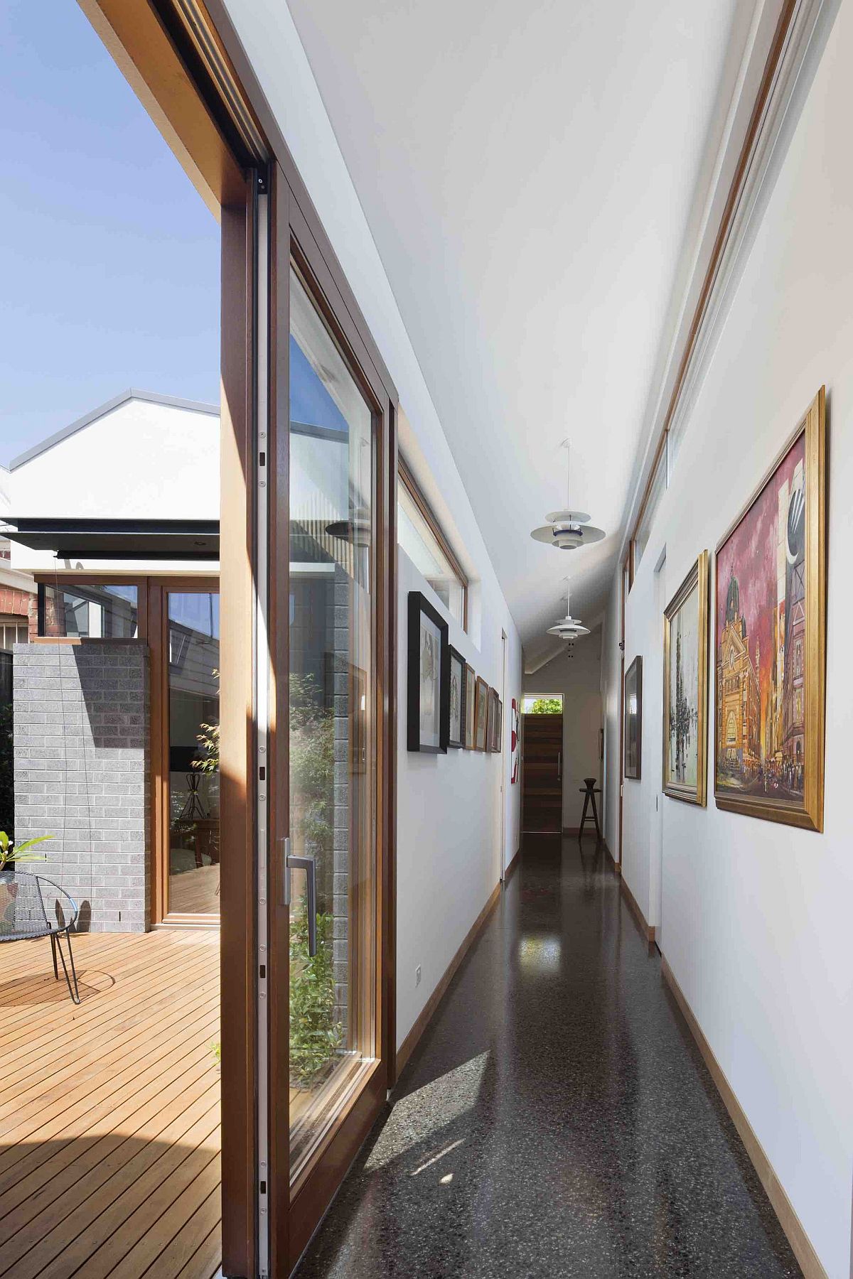 Long hallway decorated with framed artwork