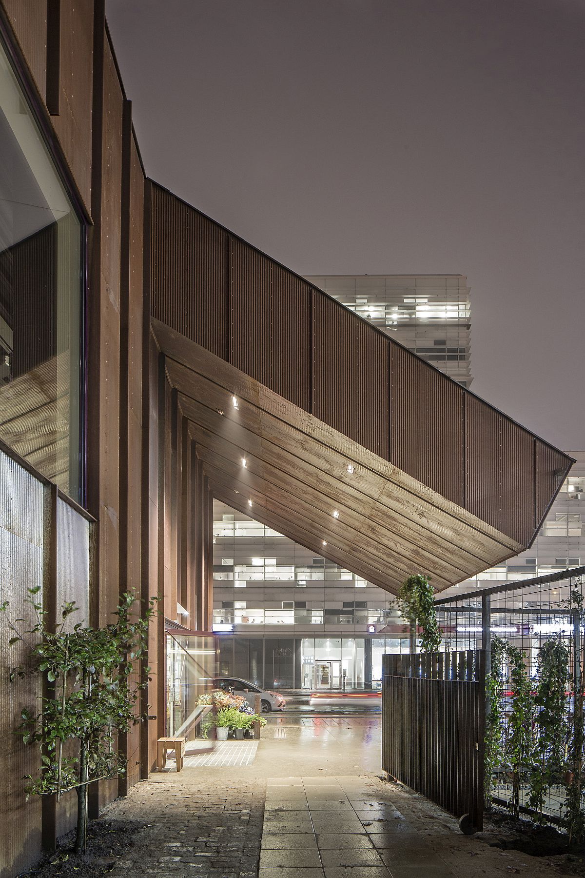 Natural vegetation fills the spaces between the old and new structure