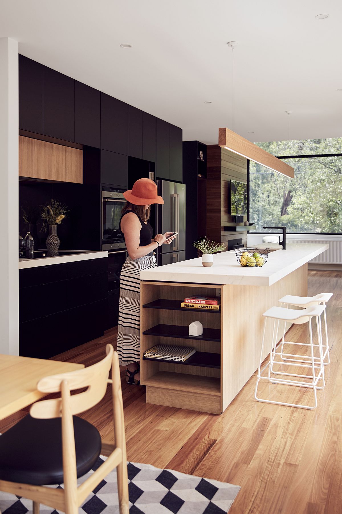 Open kitchen and dining area of the home with a dark backdrop