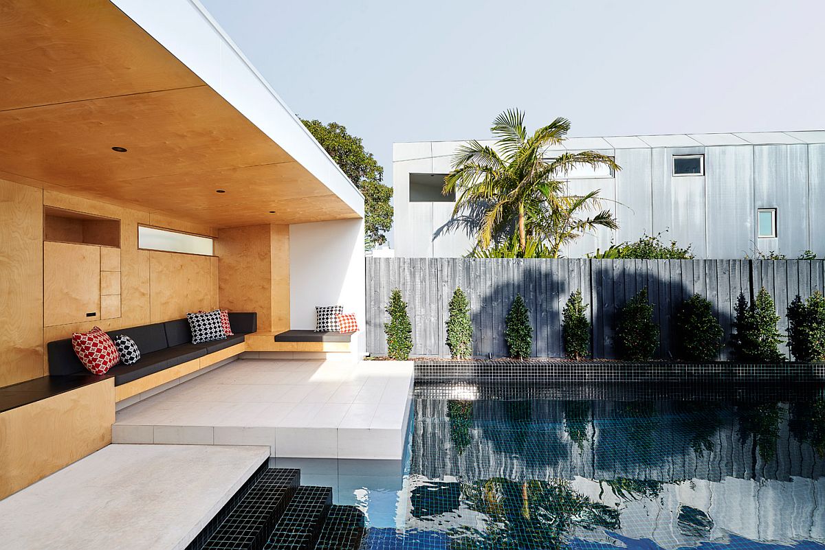 Plywood gives the hangout next to the pool a warm and cozy appeal