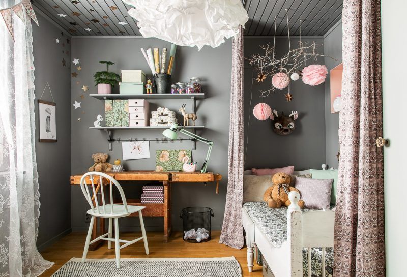 Rustic wooden furniture in a gray and pink bedroom