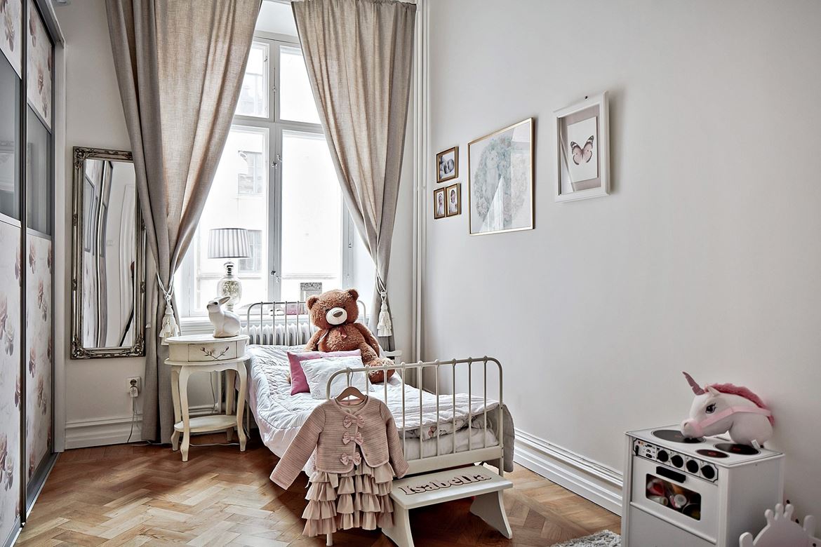 Serene bedroom with a vintage bedside table and a white iron bed