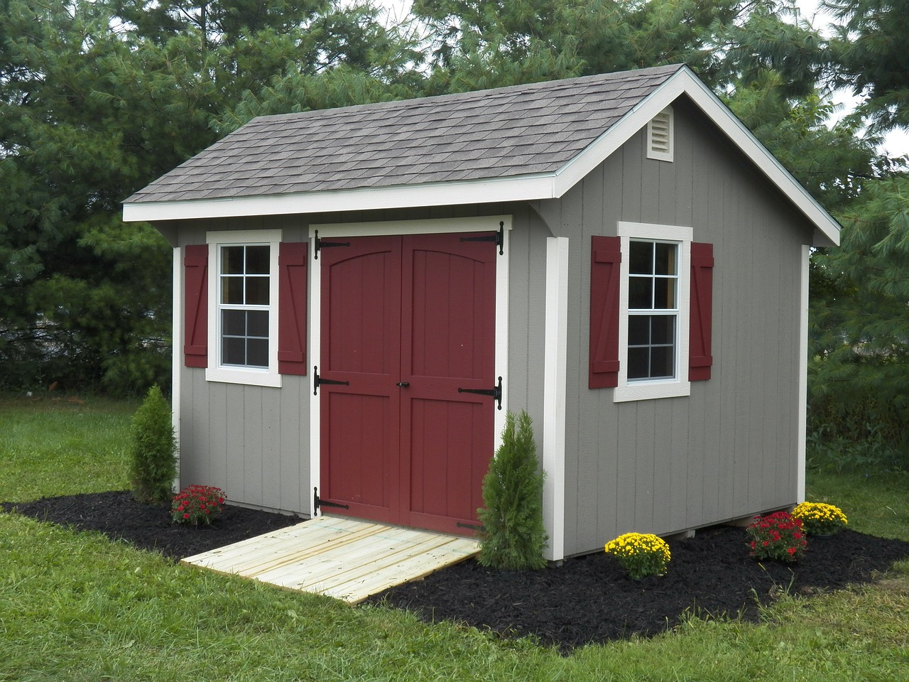Simple garden shed with a blend of gray and dark red exterior