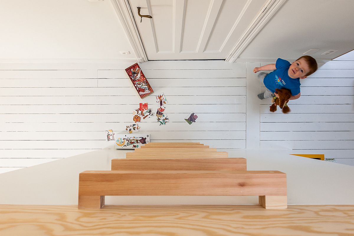 Simple wooden ladder leads to the loft play area above the beds