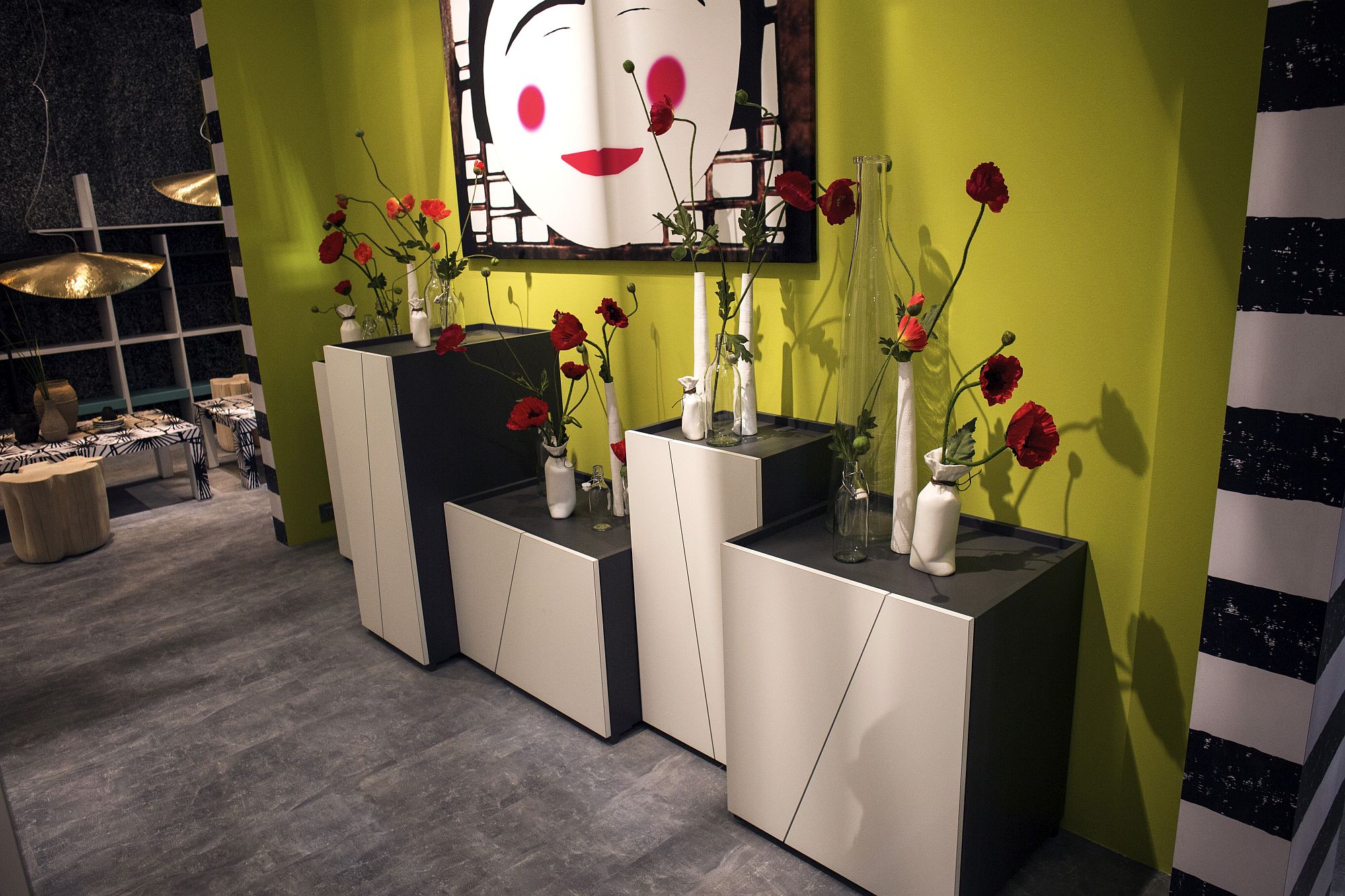 Slim white vases coupled with fabulous flowers in red