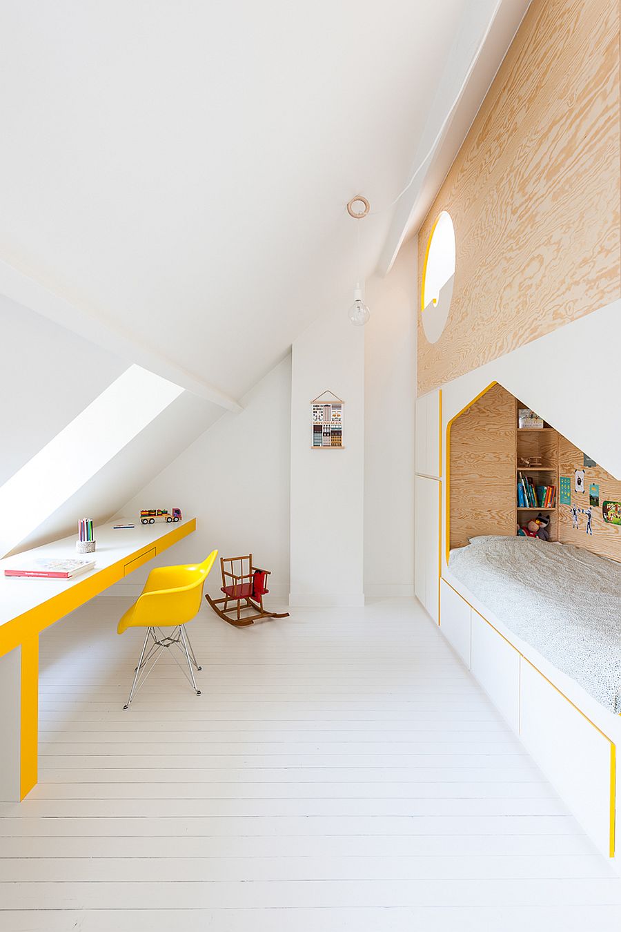 Sloping walls of the attic add to the dramatic visual