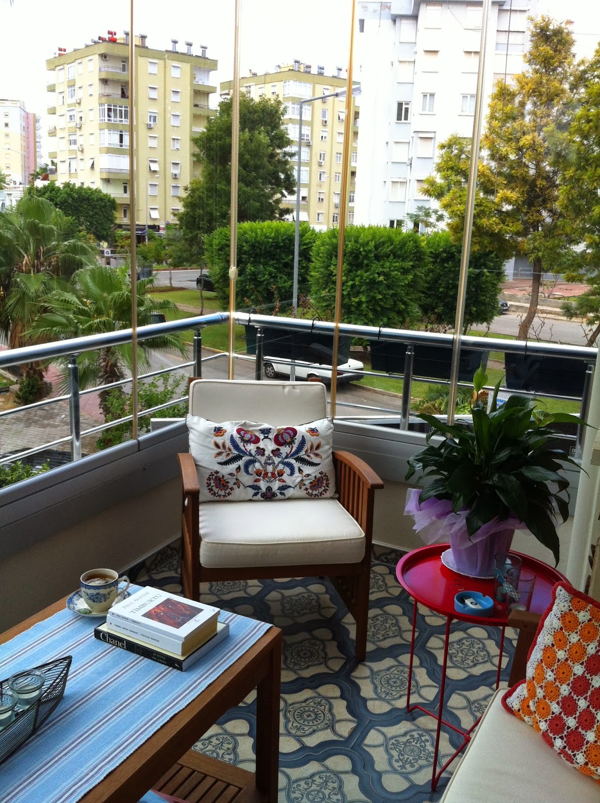 Small city balcony with a tiny magenta side table