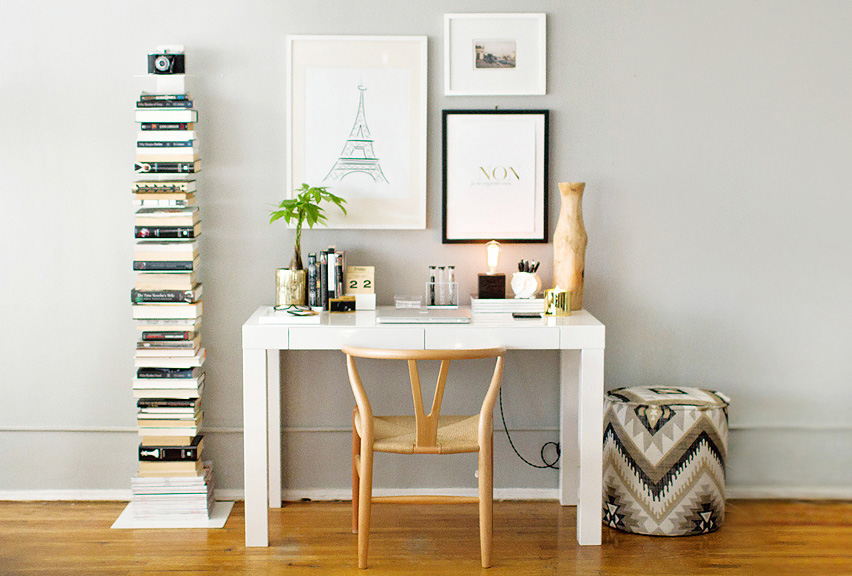 Small white office with golden items displayed on the desk