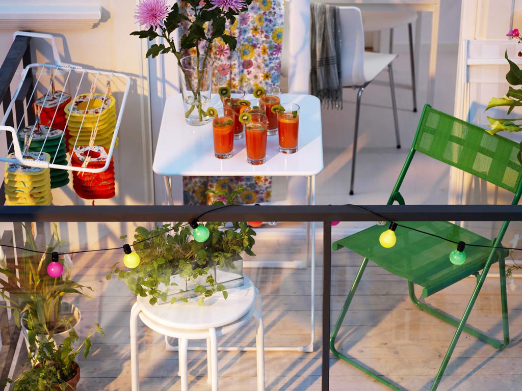 Tiny balcony with colorful string lights