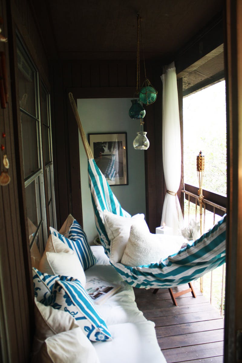 Tiny rustic balcony with blue decor pieces