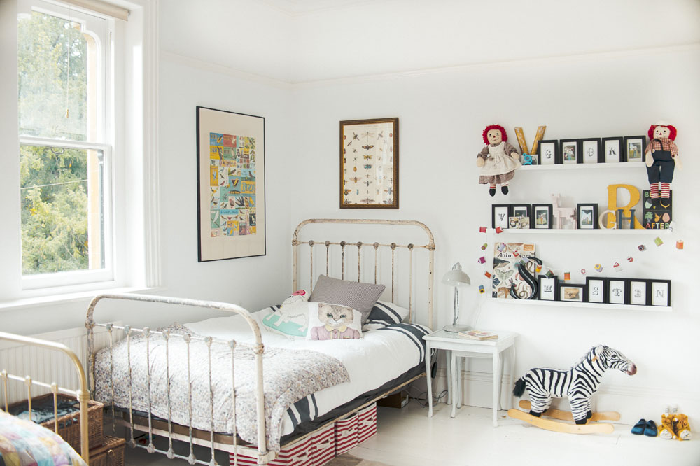 White bedroom with an eye-catching vintage iron bed