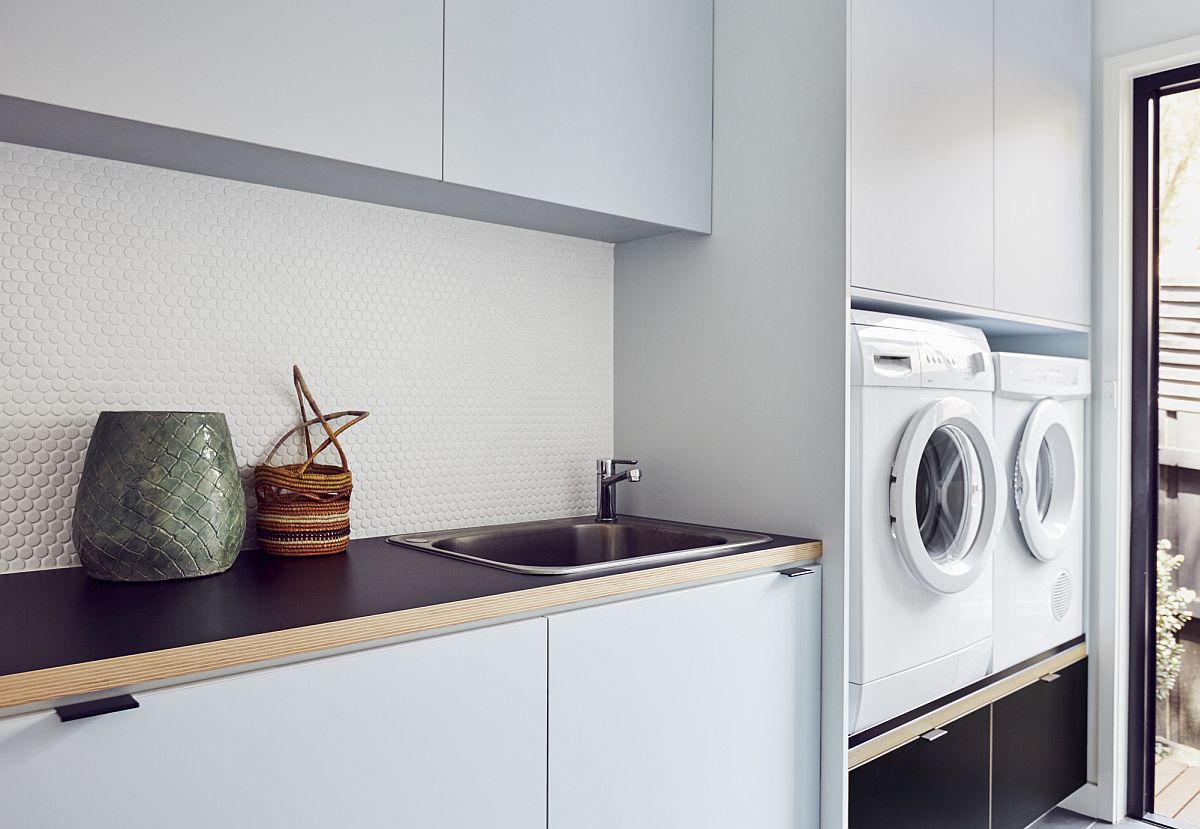 White kitchen with laundry next to it