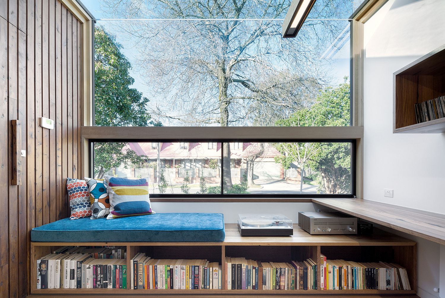 Window seat with built-in storage for a large book collection