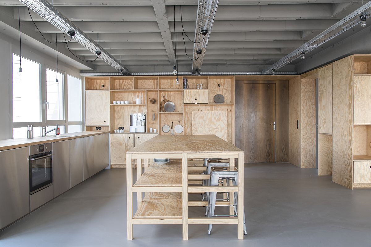 Wooden cabinetry and decor give the office kitchen a cozy look