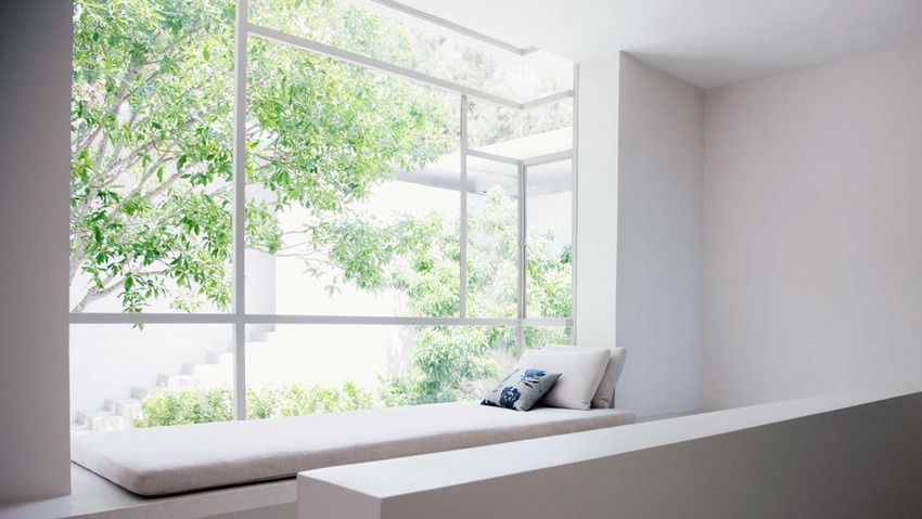 A basic white room with a big window seat