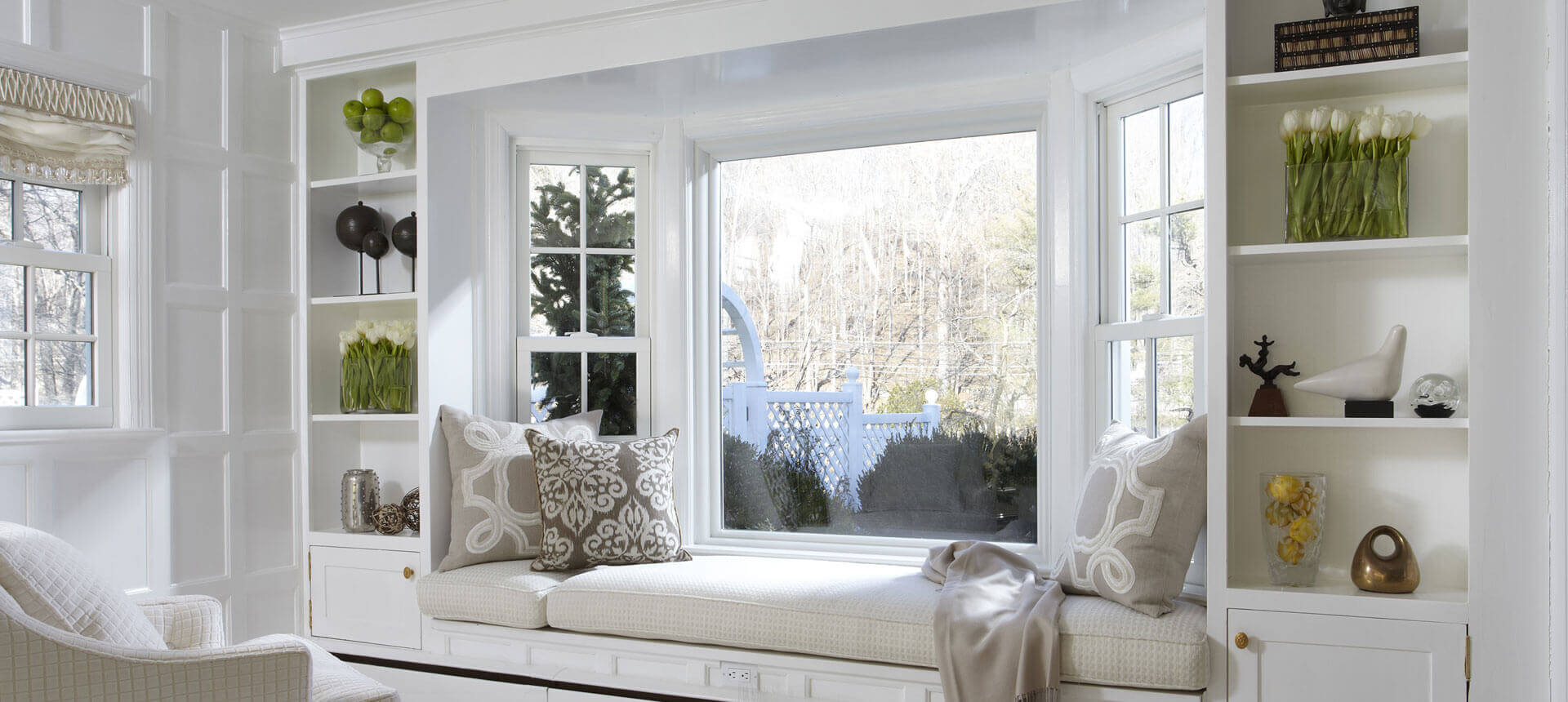 A big window seat as a focal point in a minimalist room