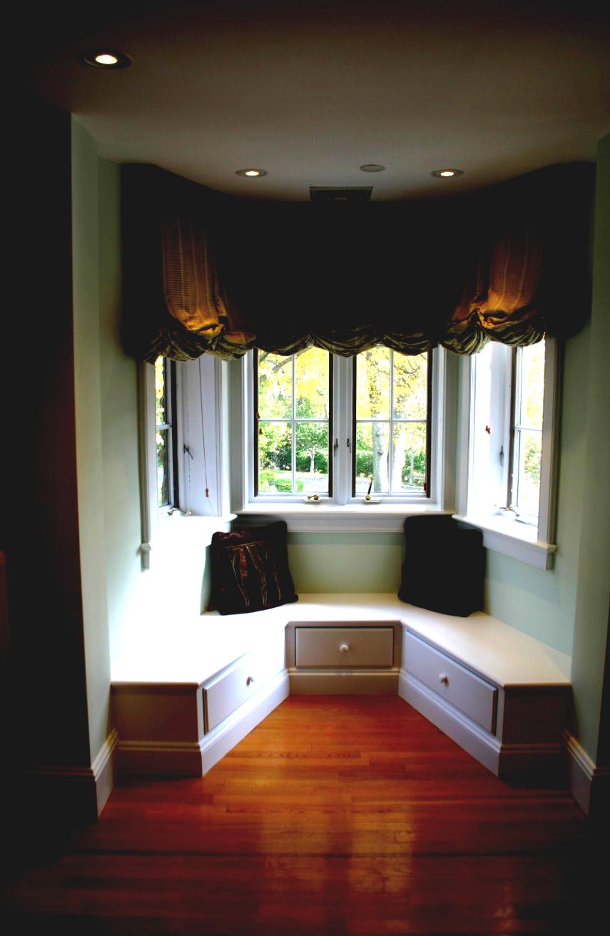 A darker room is balanced by a plain white window seat