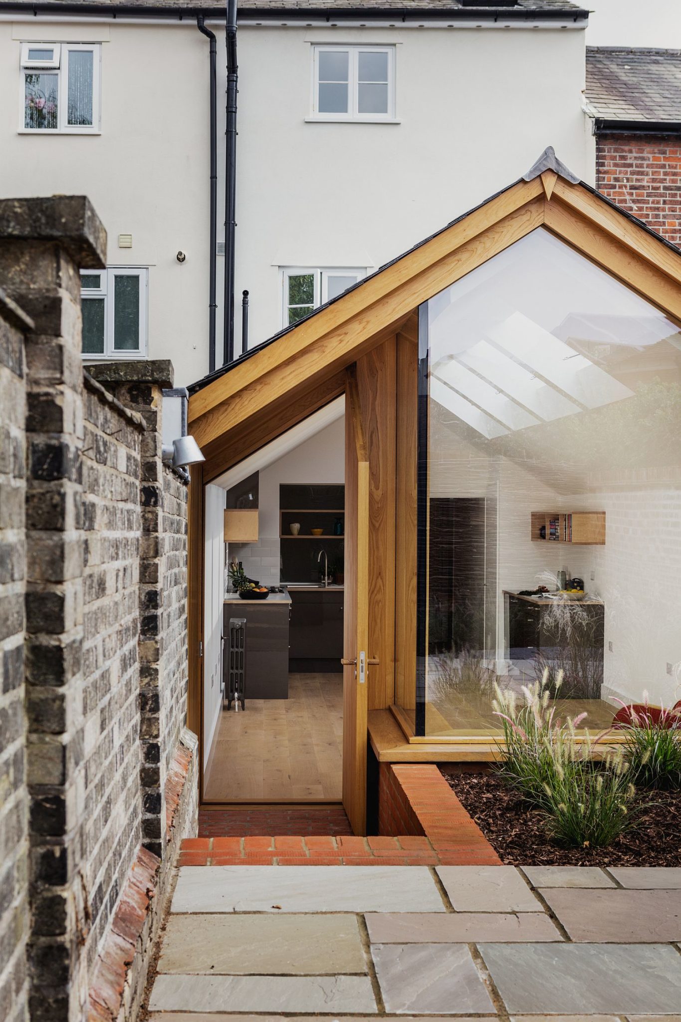 A difference in flooring along with height delineates the garden from the extension