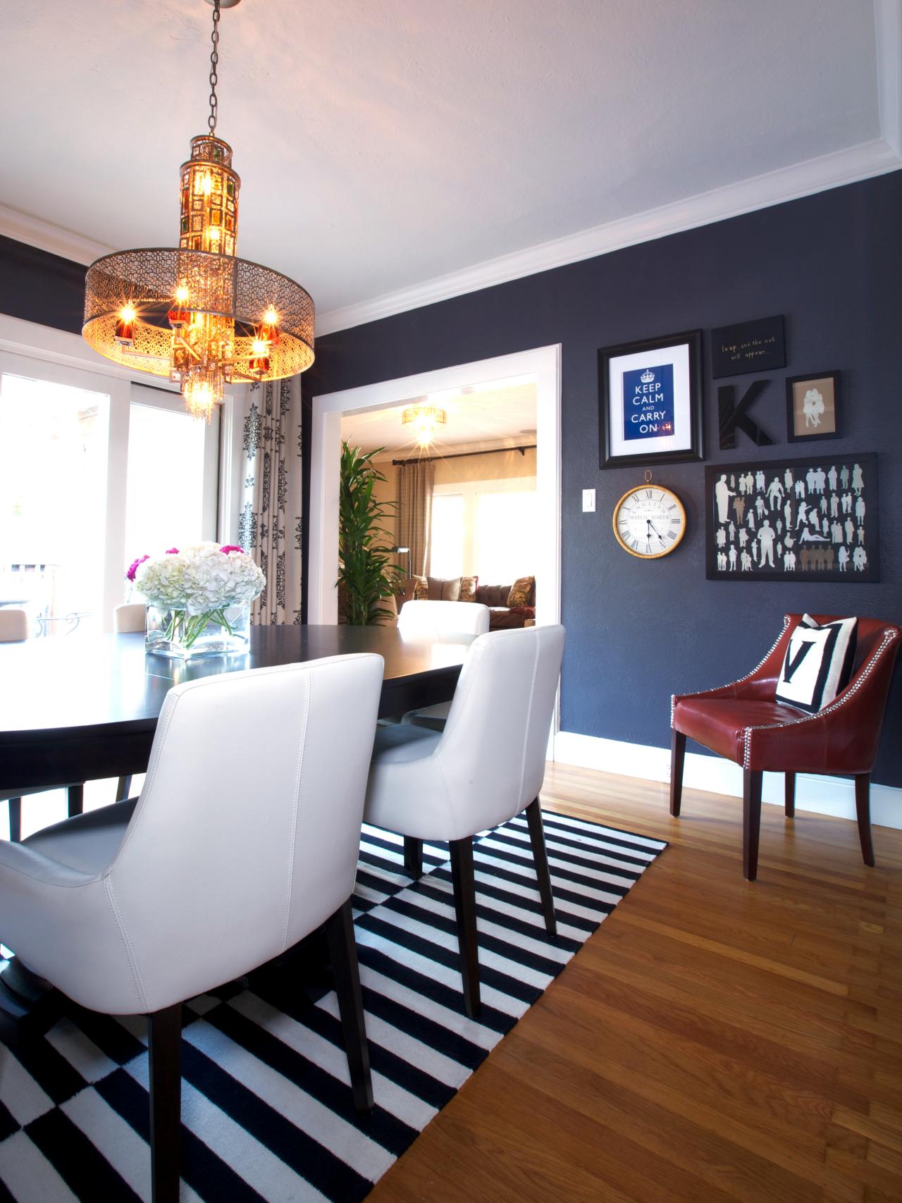 A dim contemporary dining room with a monochrome dinner table rug