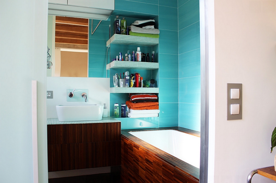 A small bathroom with a turquoise interior