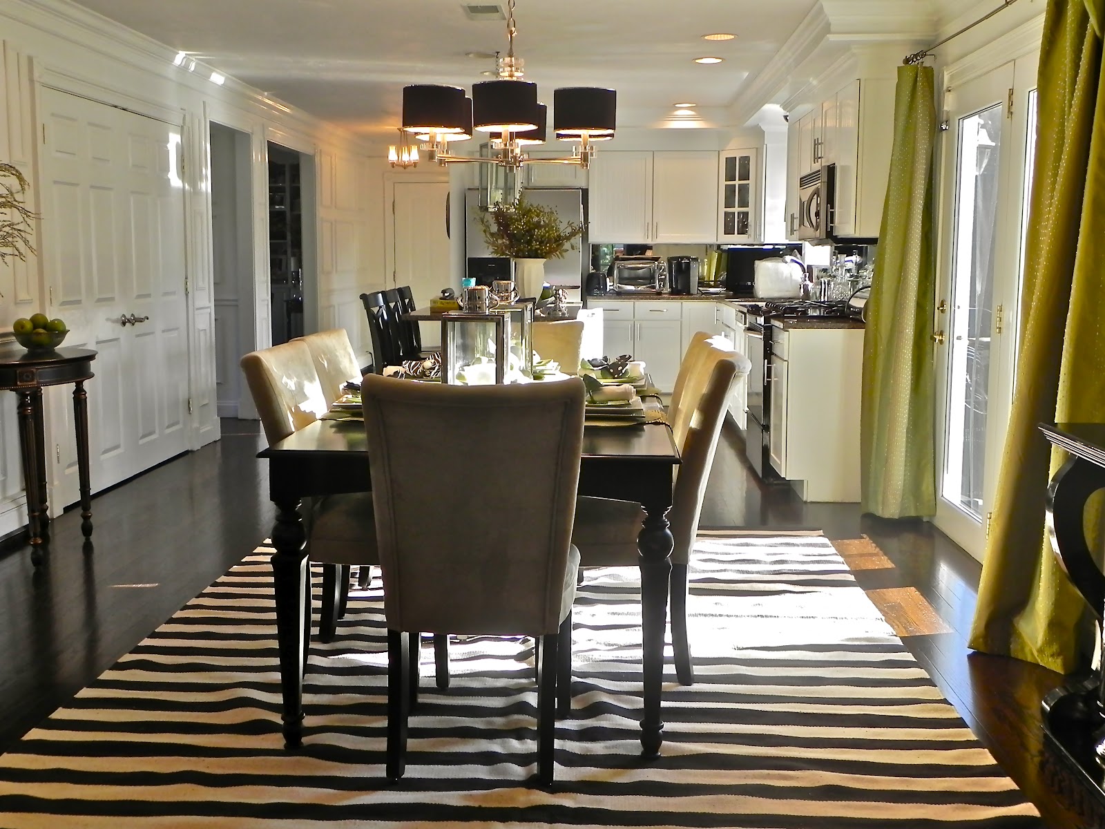 A striped rug under the dining table is the focus of the dining room