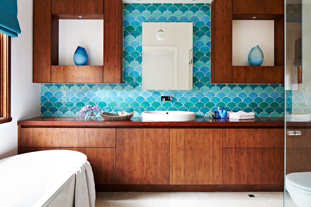 Bathroom with turquoise tiles that resemble fish scales