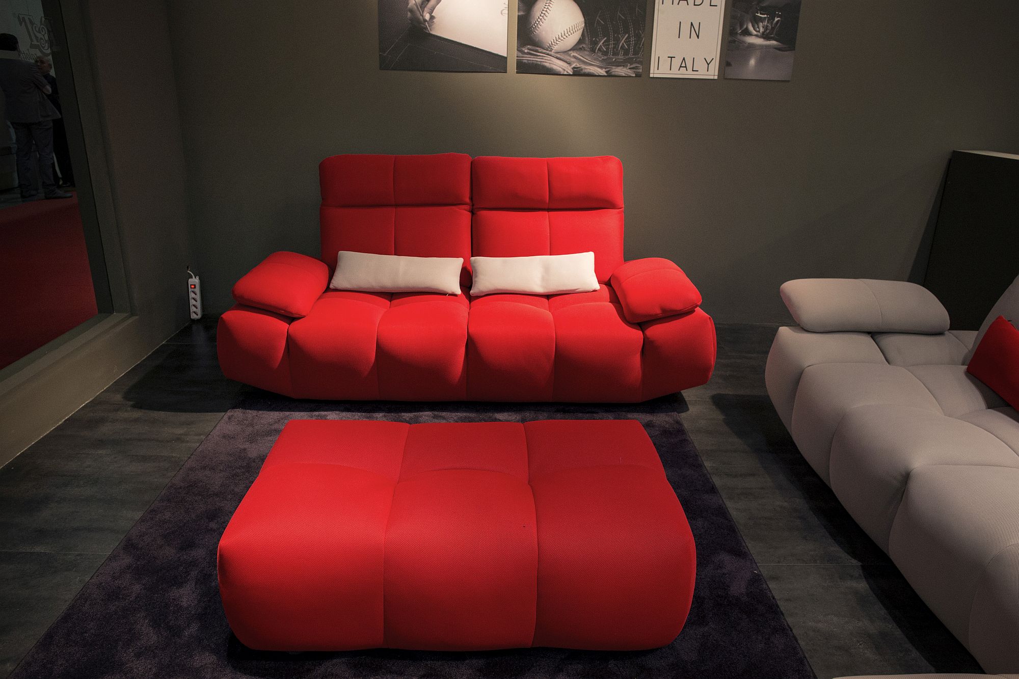 Bold red sofa with modern design and a matching tufted coffee table