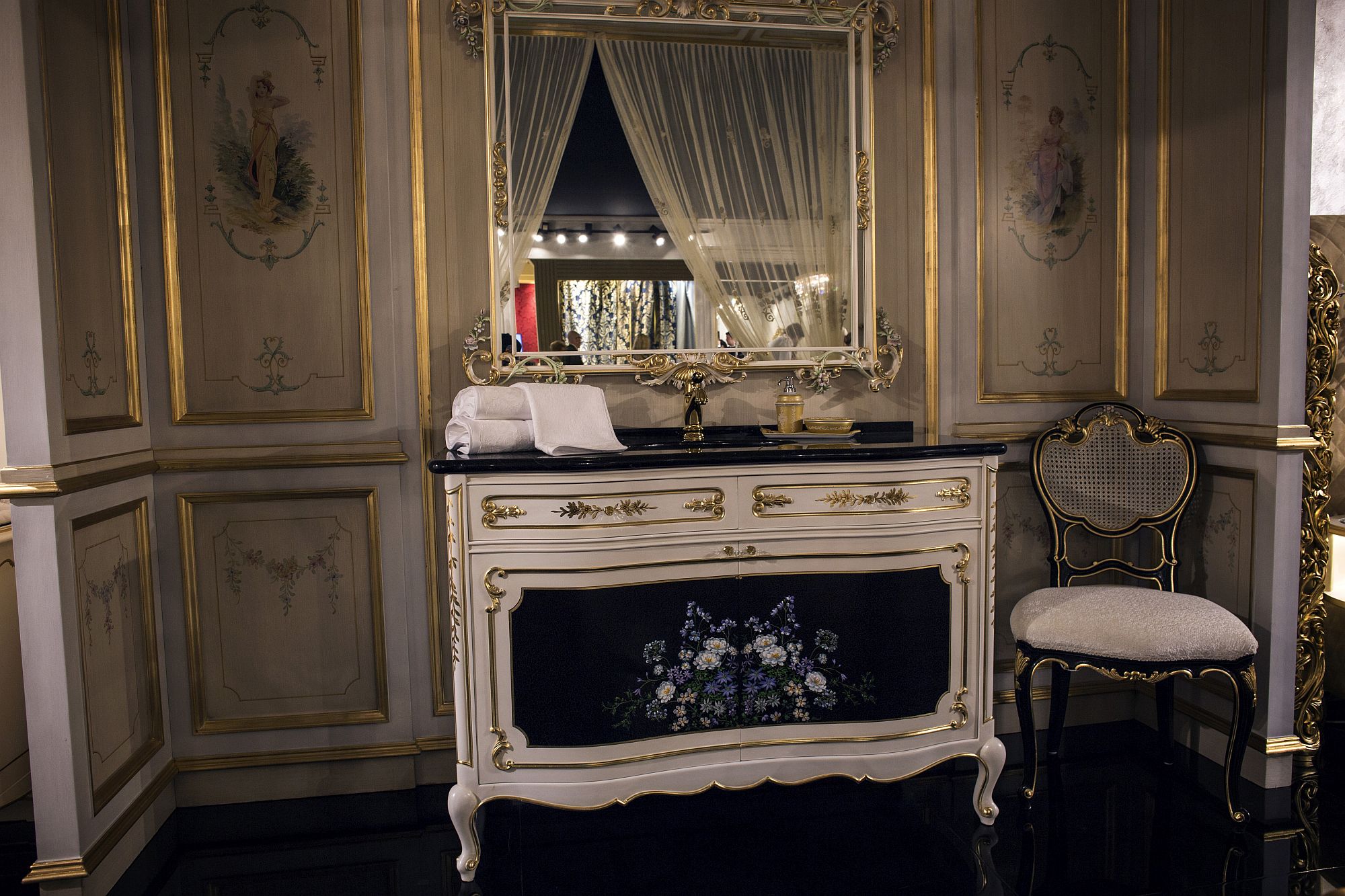 Classic entryway with gold framed mirror