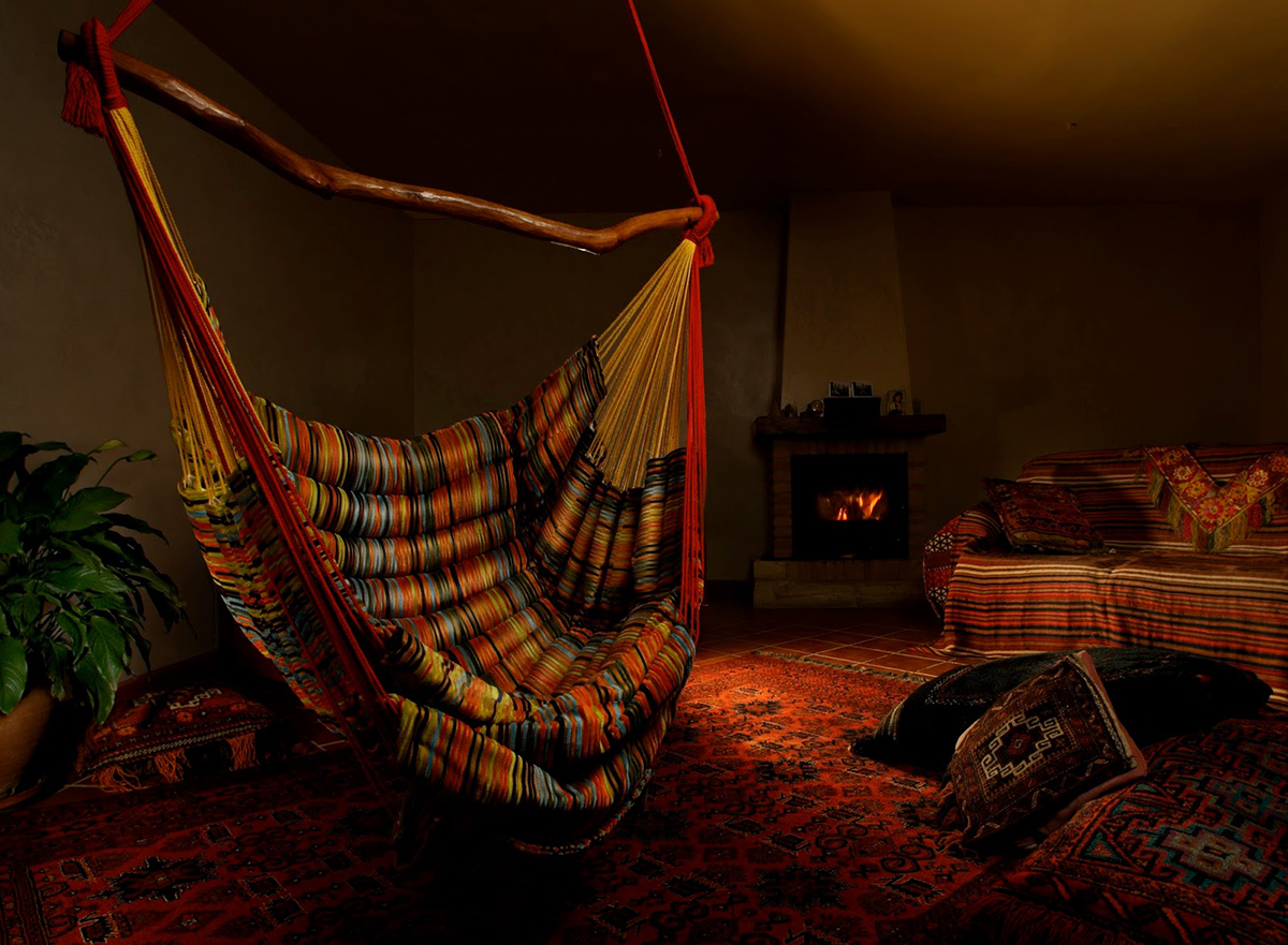 Colorful boho hammock chair in an oriental room