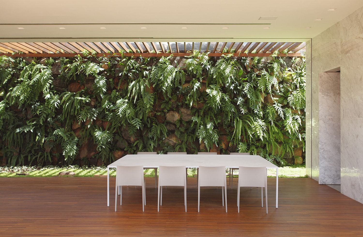 Custom wall of stones filled with greenery and a unique water supply system