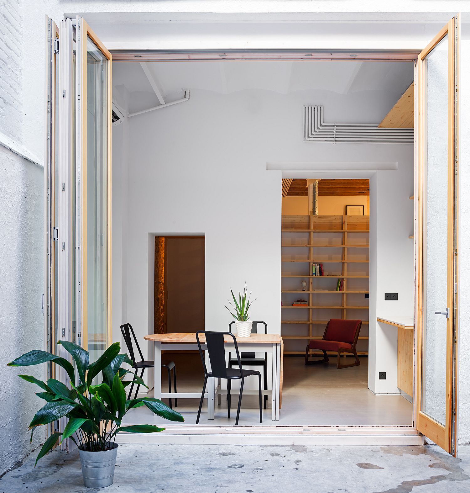 Dining area connected with the patio of the small Barcelona apartment