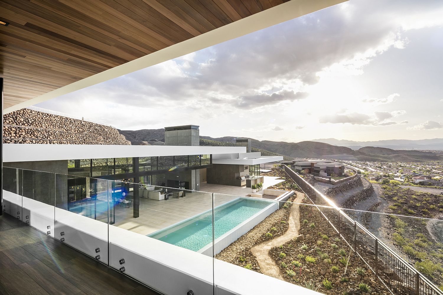 Elegant landscape and pool deck viewed from the top level