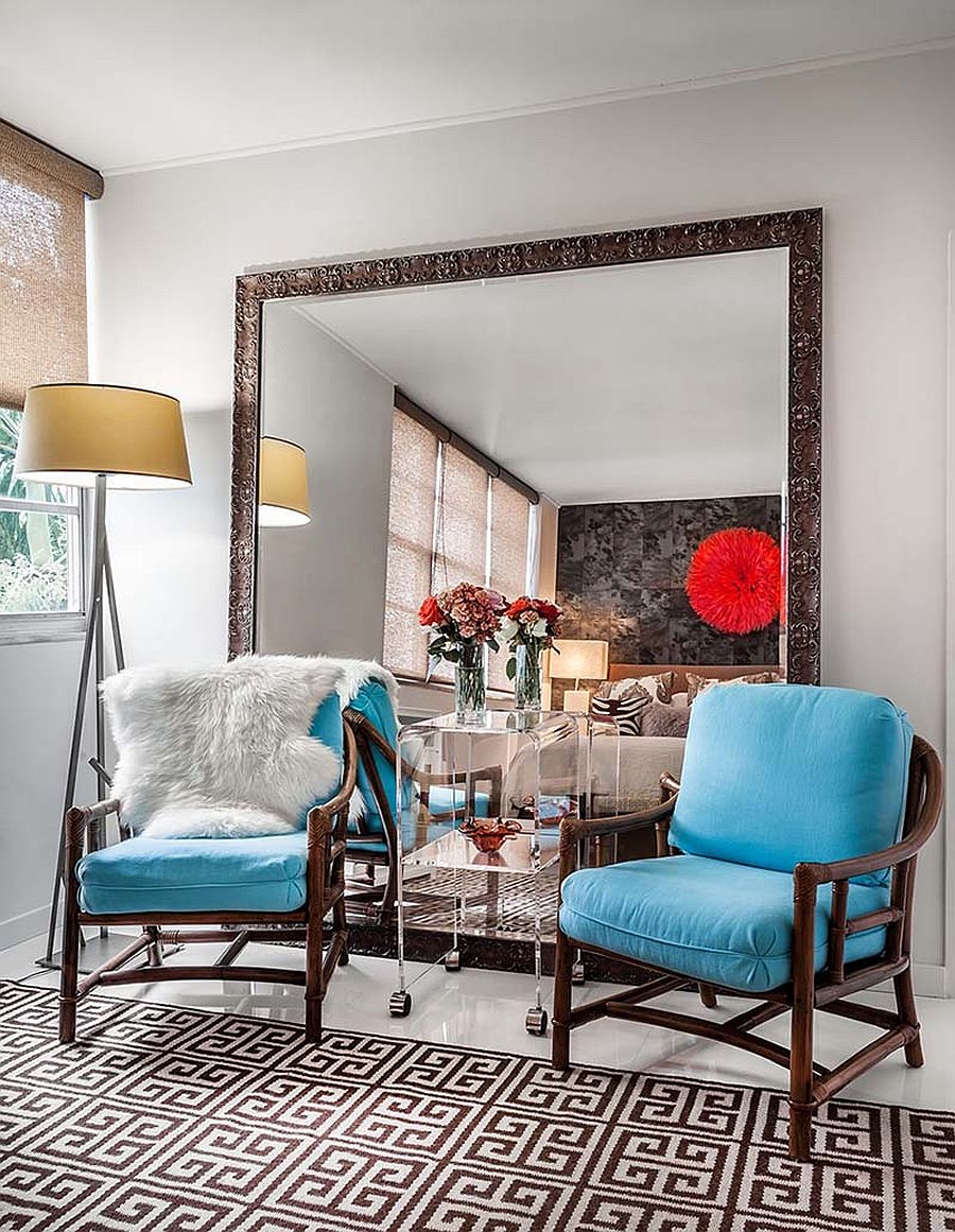 Gorgeous use of large mirror inside the sitting room of Miami home