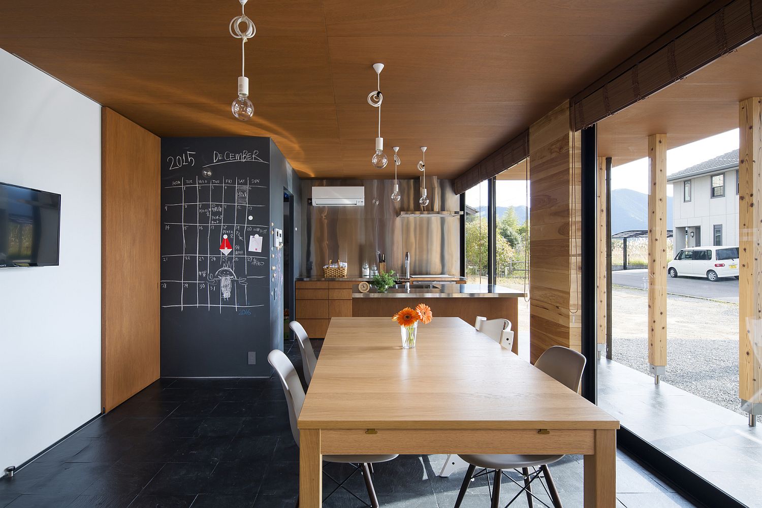 Kitchen and dining area of the Japanese home with cedar ceiling