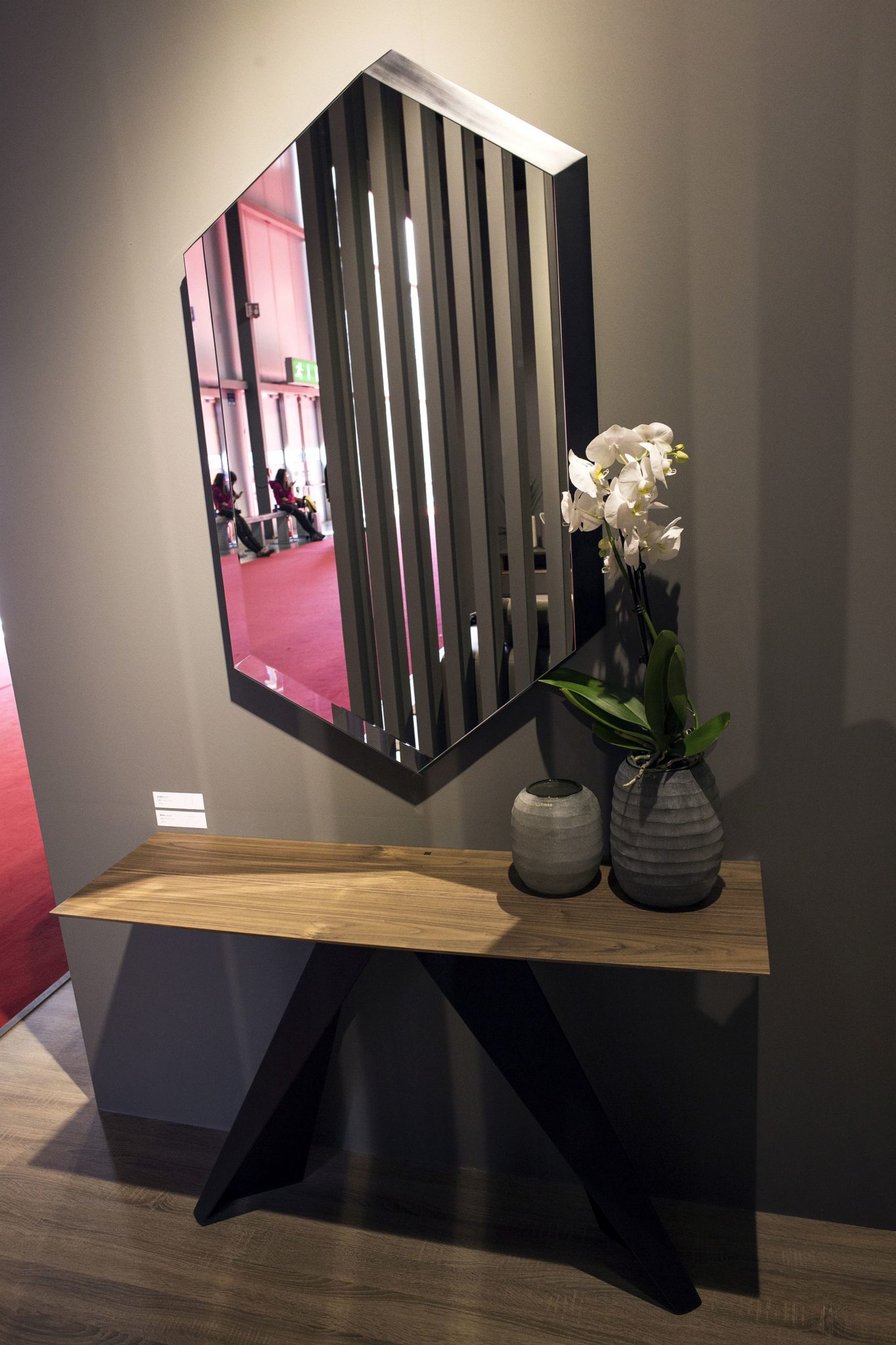 Large-hexagonal-mirror-above-a-slim-console-for-the-entryway