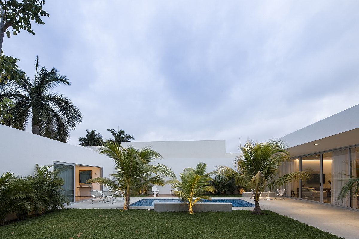 Lovely yard and pool connecting the different wings of the house