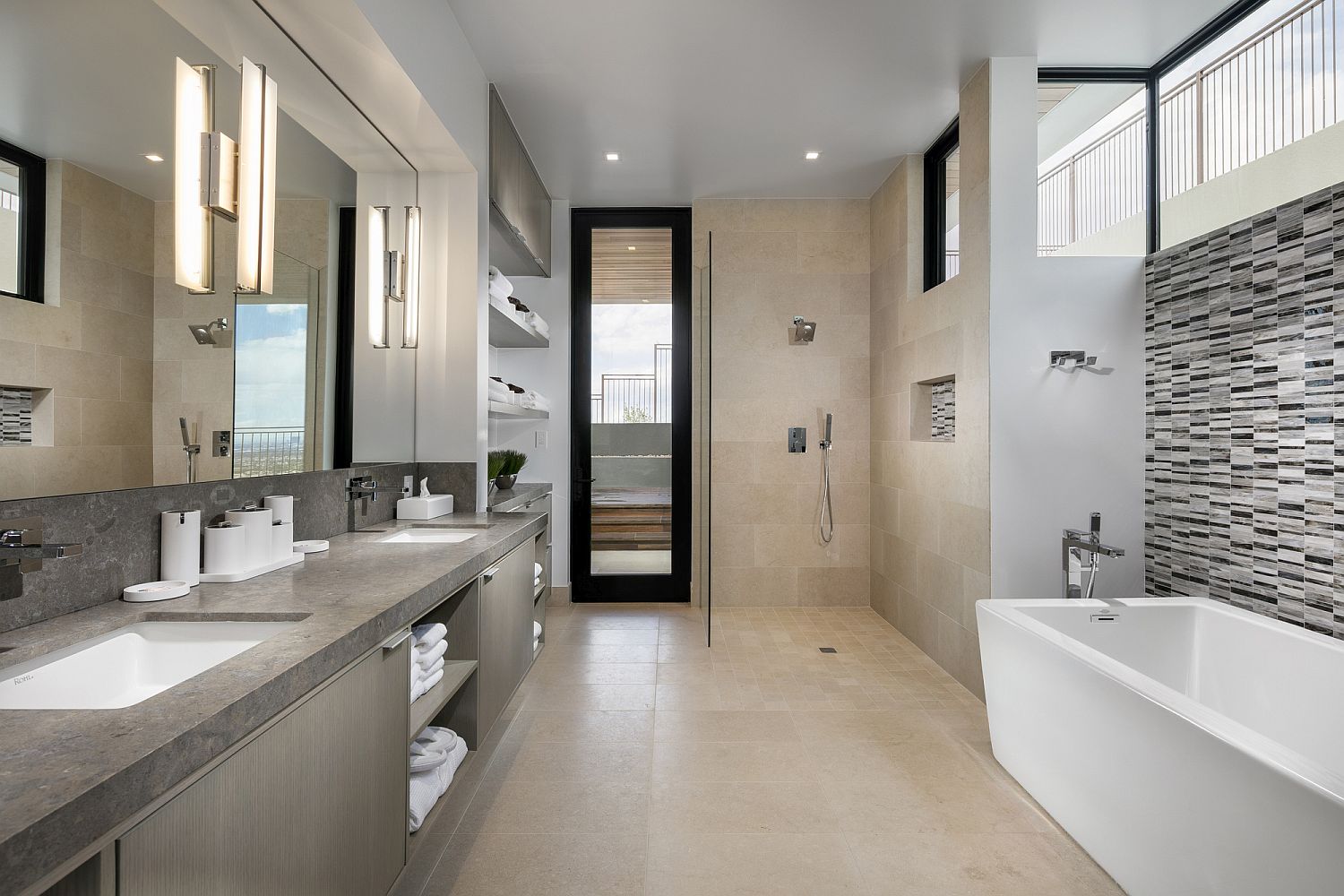 Master bathroom with white bathtub and vanity with ample storage