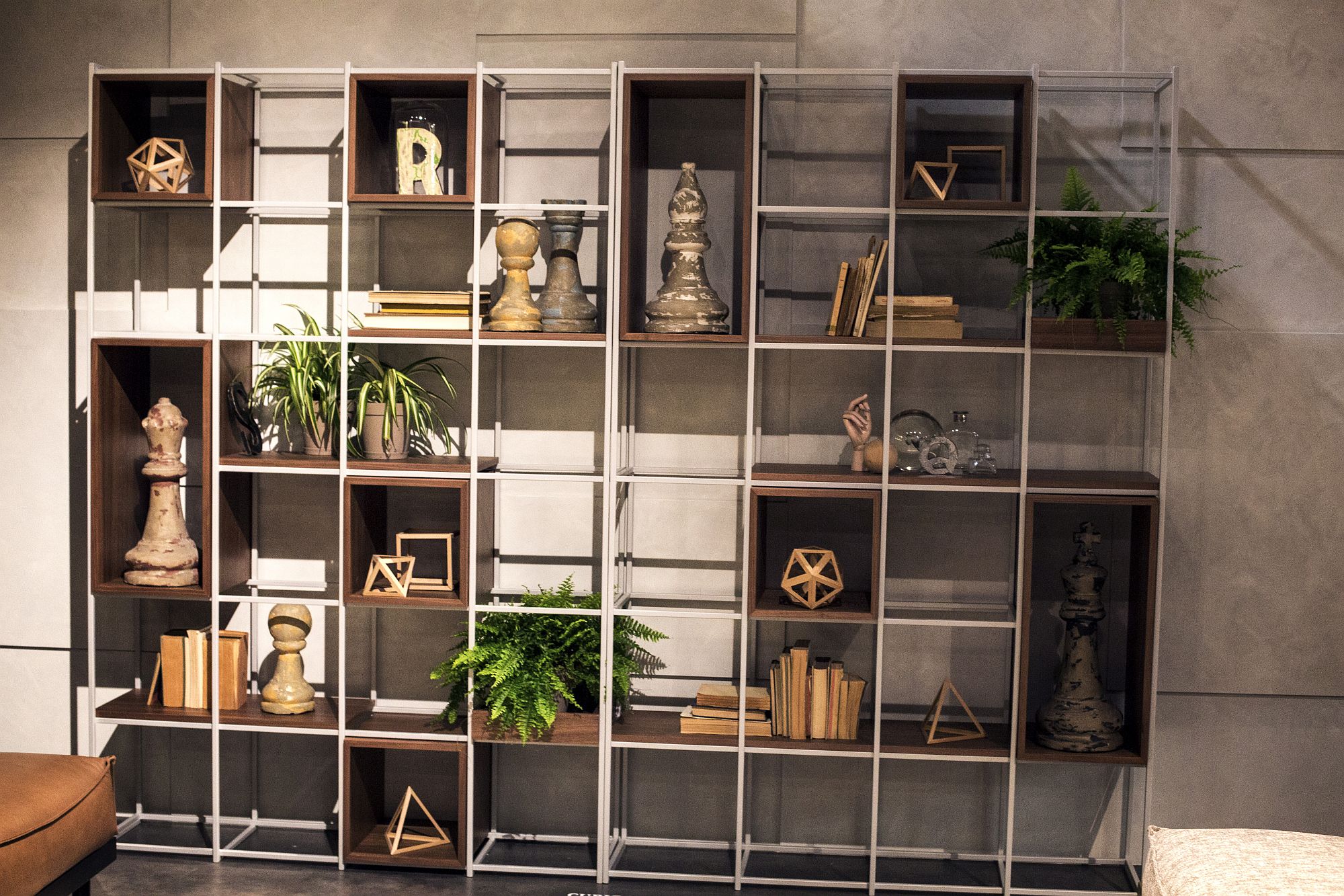 Metallic frame holds wooden boxes that create a cool display