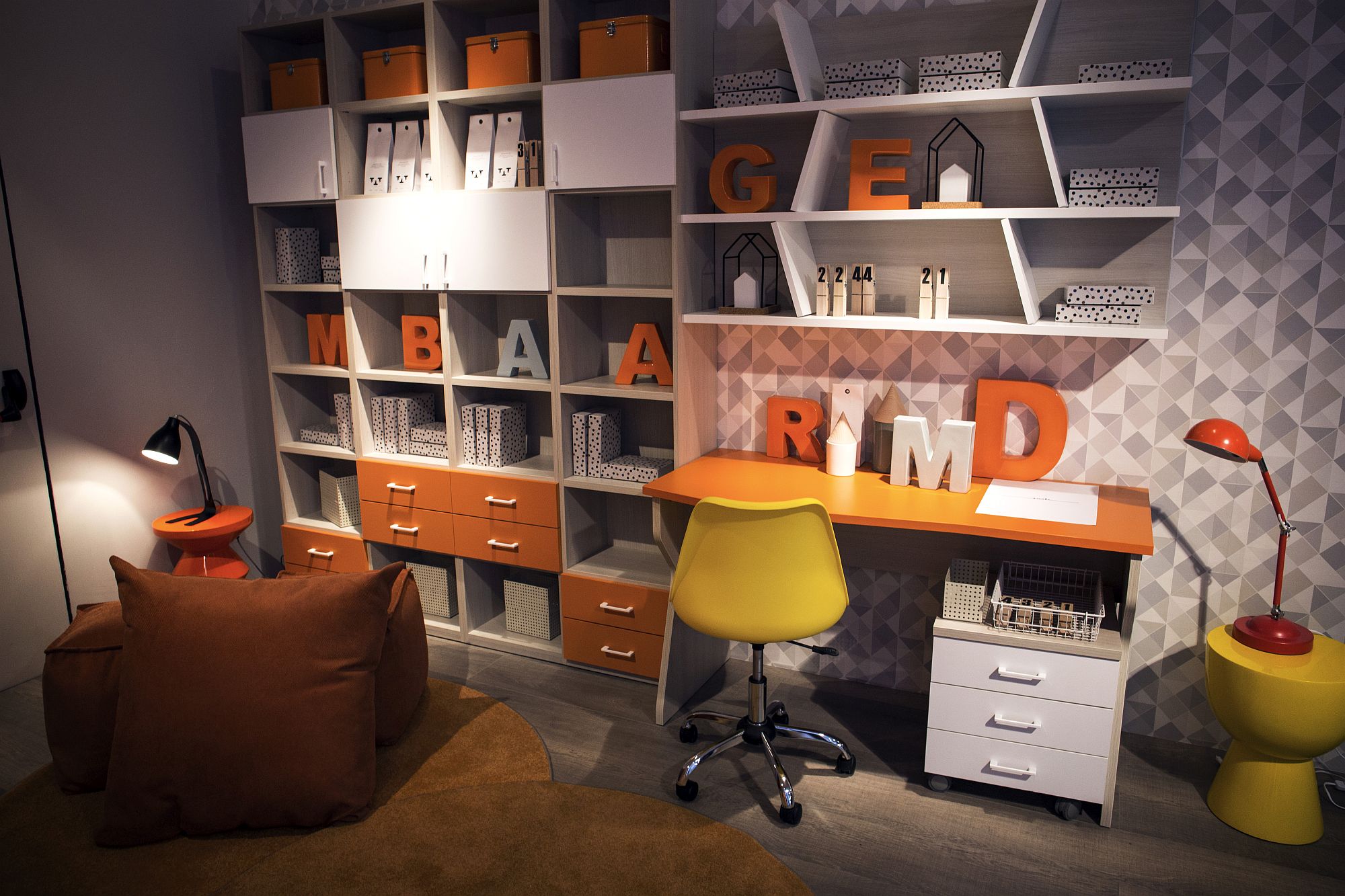 Modular shelving coupled with smart workstation and pops of yellow and orange