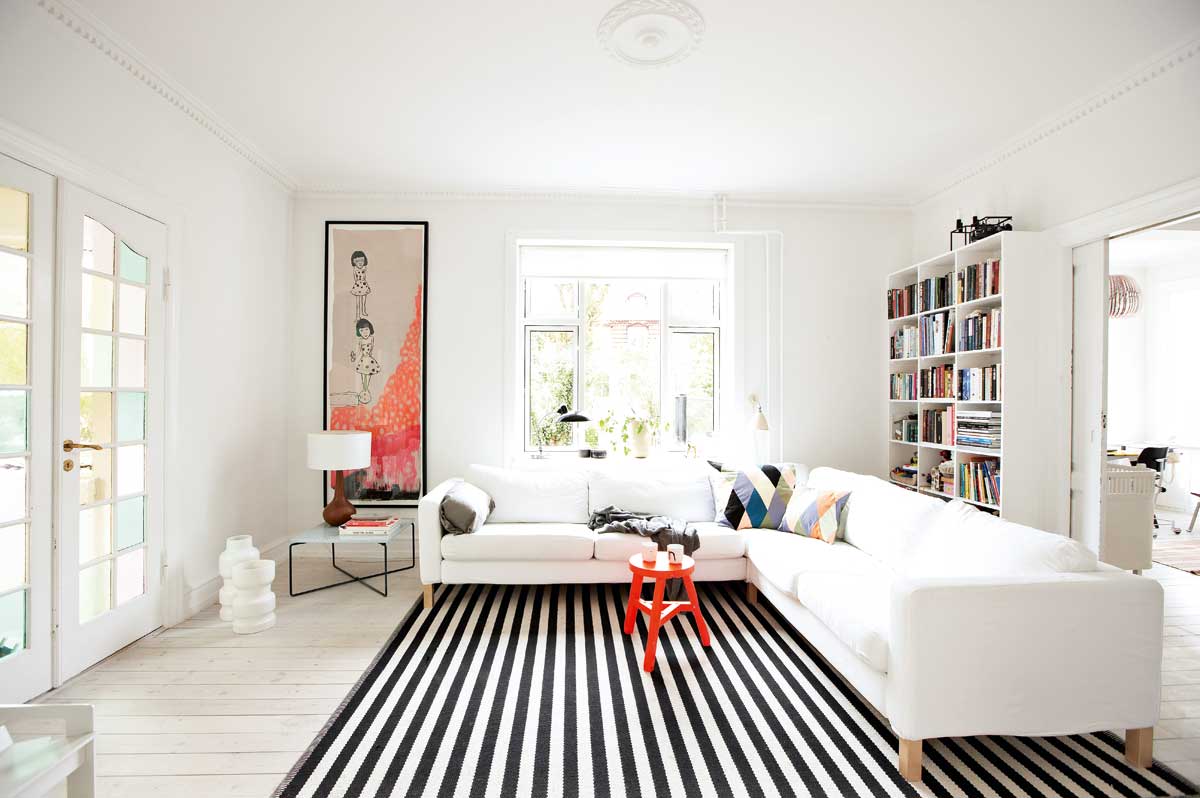 Monochrome striped rug extending through the bright living room