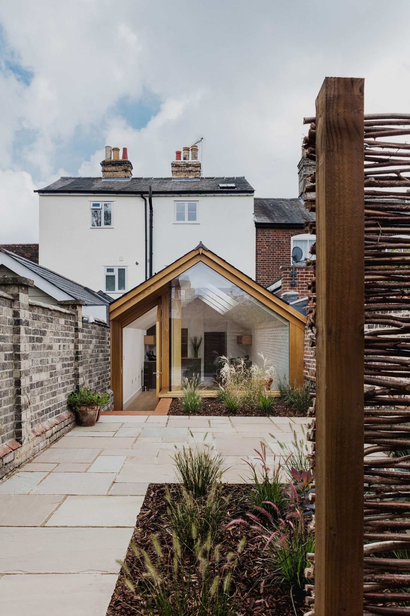 Oak, brick and frameless glazing create an elegant rear extension to heritage home