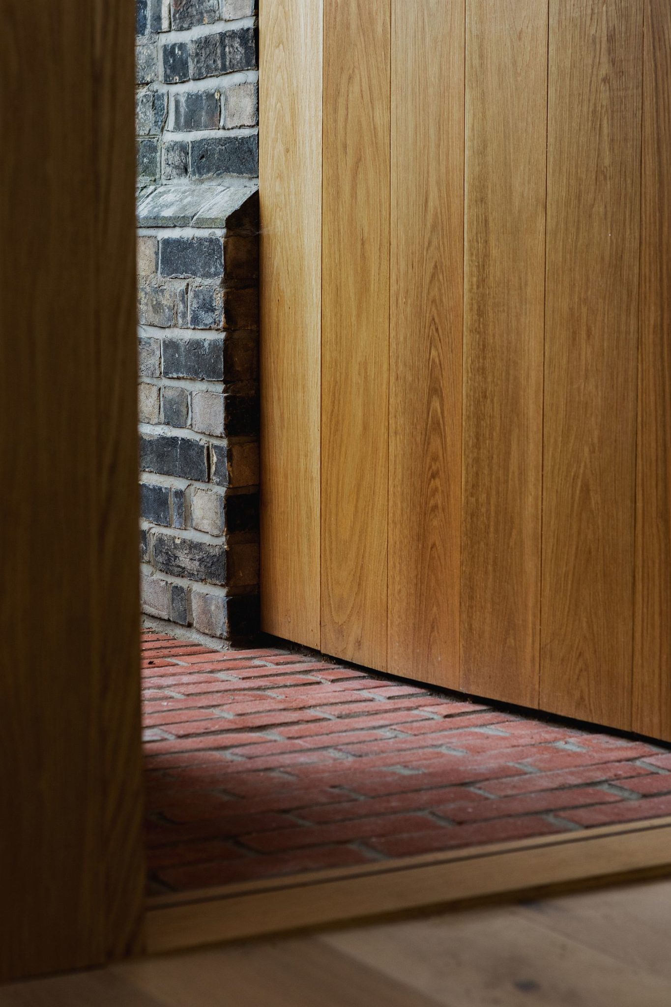 Old brick flooring sits next to modern oak floor of the new extension